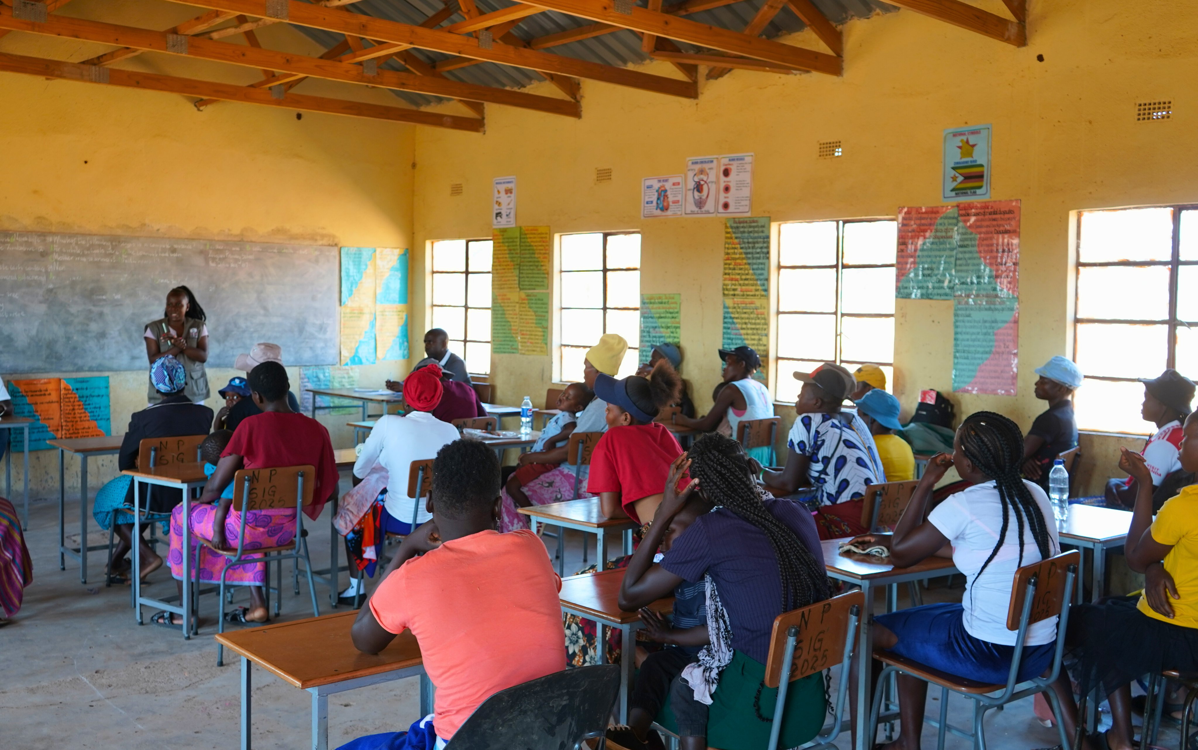 Men engaged in discussion at WLSA Zimbabwe community outreach